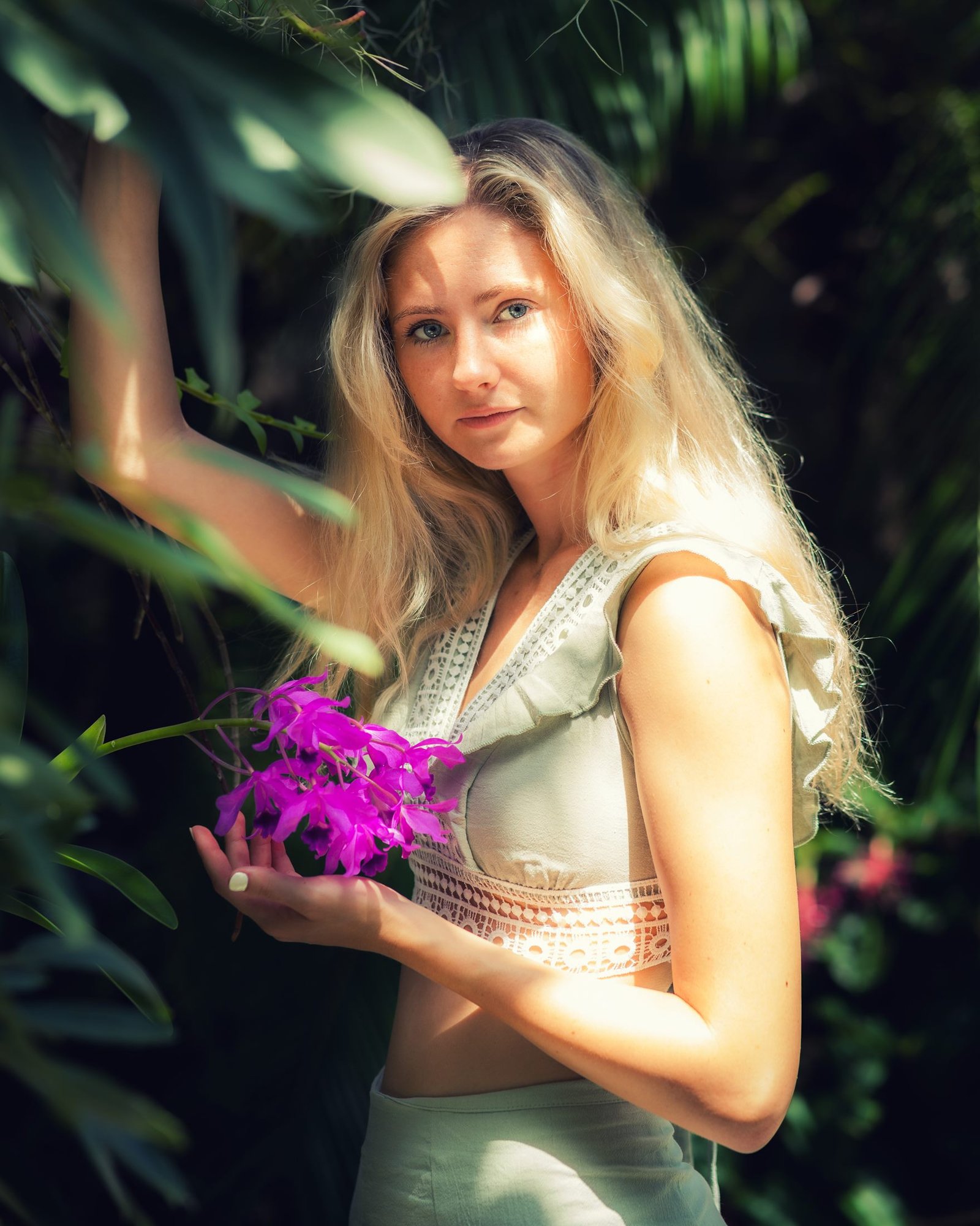 Golden-hour portrait among orchids