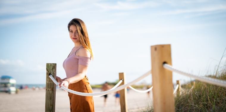 Portrait at the beach boardwalk rope fence