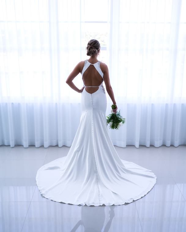 Bride from behind, gown train spread across the floor