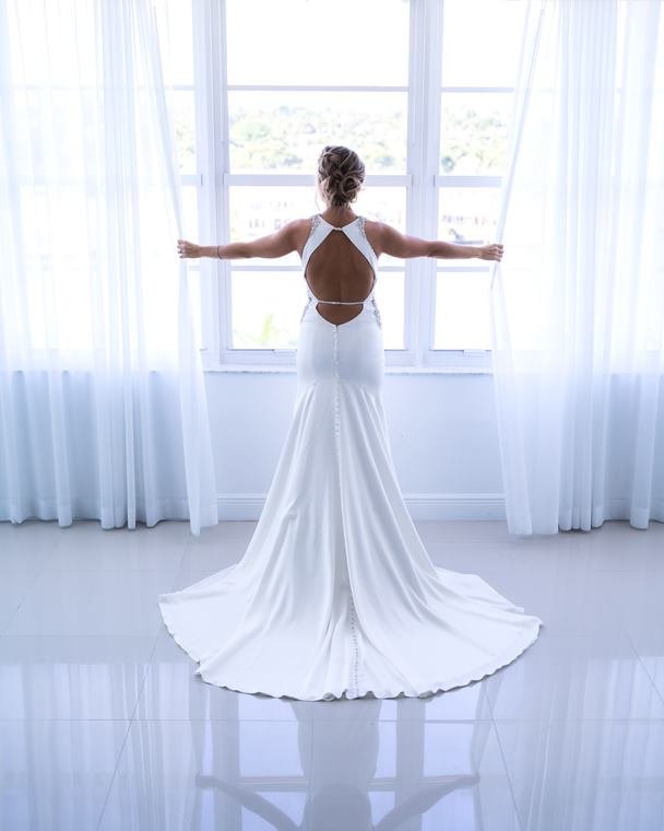 Bridal gown from behind in window light