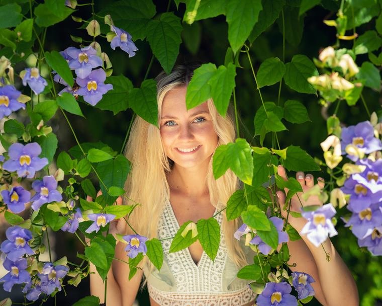 Smiling portrait among flowering vines