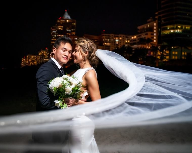 Couple with veil against the city at night