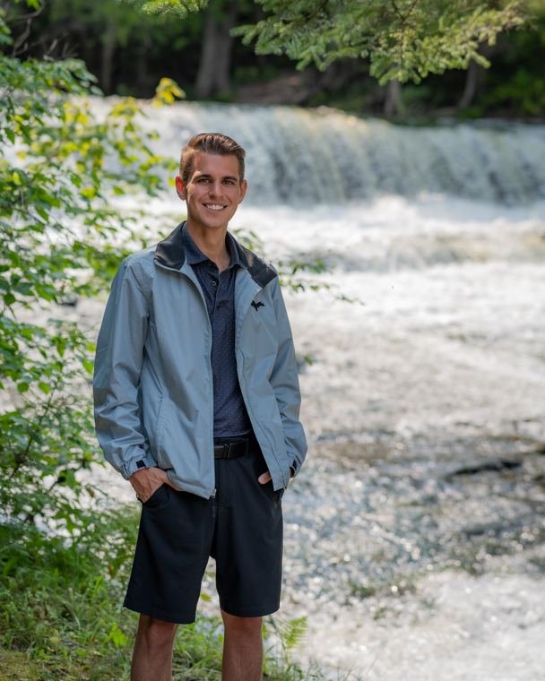 Portrait beside a waterfall in summer
