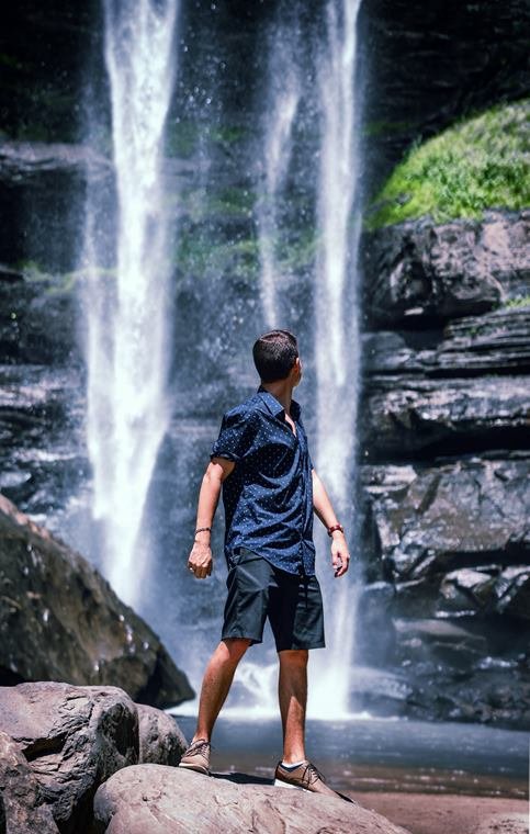 Portrait standing before a waterfall